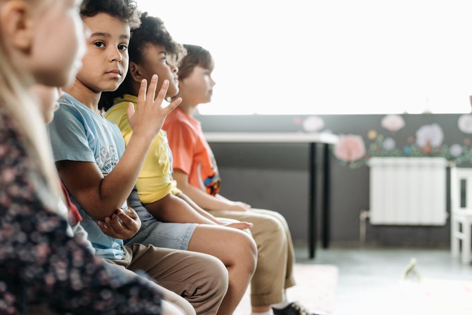 A diverse group of happy children playfully engaged in yoga inside a bright, sunlit room